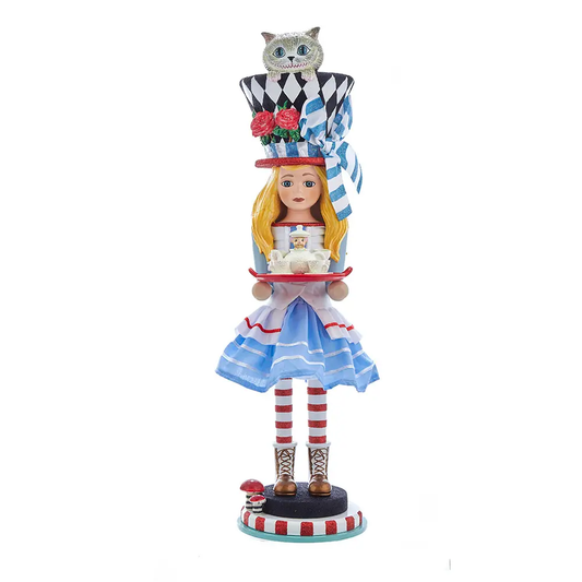This Hollywood Nutcrackers™ Alice Nutcracker is inspired by Lewis Carroll's 1865 novel Alice's Adventures in Wonderland. Alice is featured here with a tea set and topped off with a black-and-white diamond patterned top hat. Cheshire cat is peeking out of the hat.