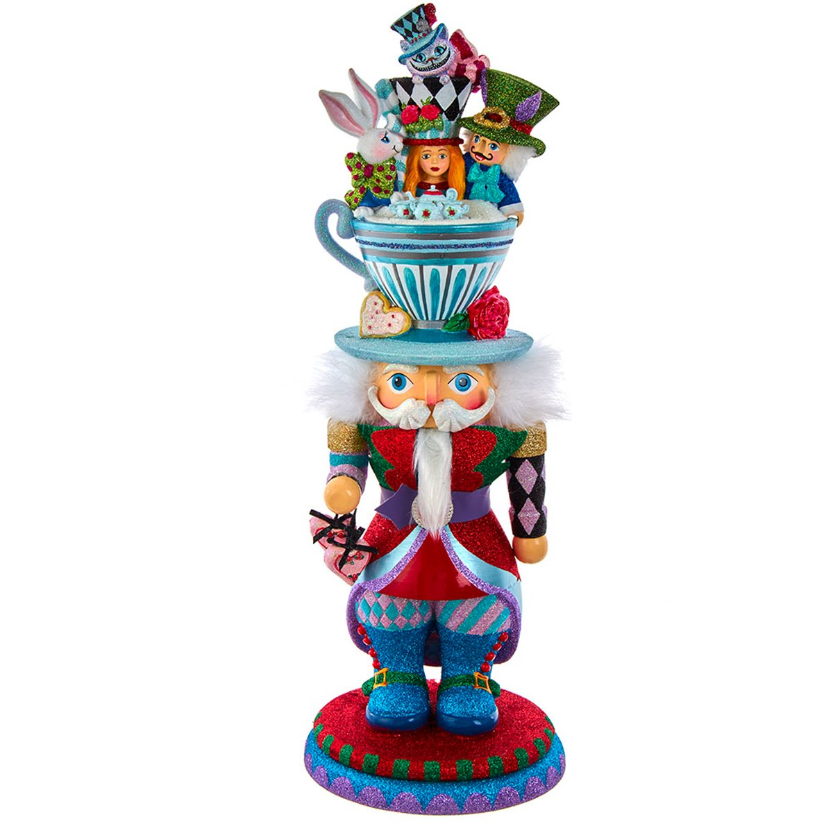 This 18-inch Alice Teacup Hat Nutcracker is inspired by Lewis Carroll's 1865 novel Alice's Adventures in Wonderland. It features a nutcracker in a red, blue, pink and green glittered color scheme standing on a matching glittered base, His glittered teacup hat is filled with characters from the beloved novel and is decorated with a hear and red rose.